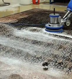 Professional rug cleaning with a rotary floor machine and shampoo foam, deep-cleaning an area rug El Paso, TX.